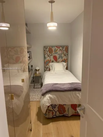 a bedroom with a bed and a mirror