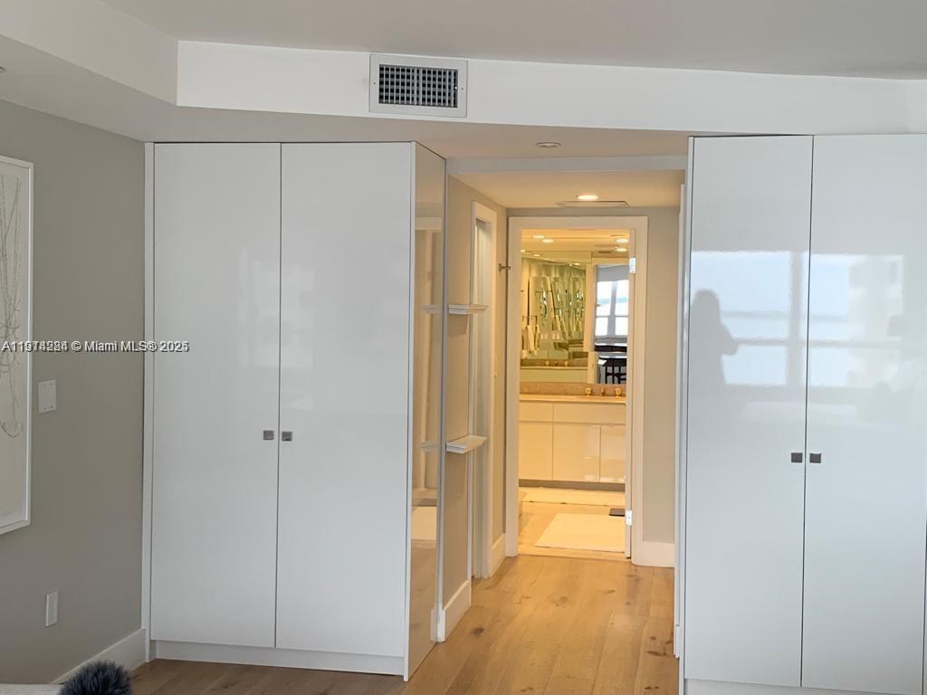 2 Grove Isle Drive, Unit B1507 Miami, FL 33133 - Photo 9 of 13 a view of a hallway with wooden floor
