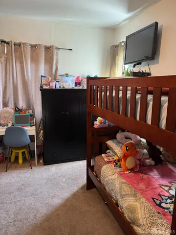 a bathroom with a sink a toilet a mirror and shower curtain
