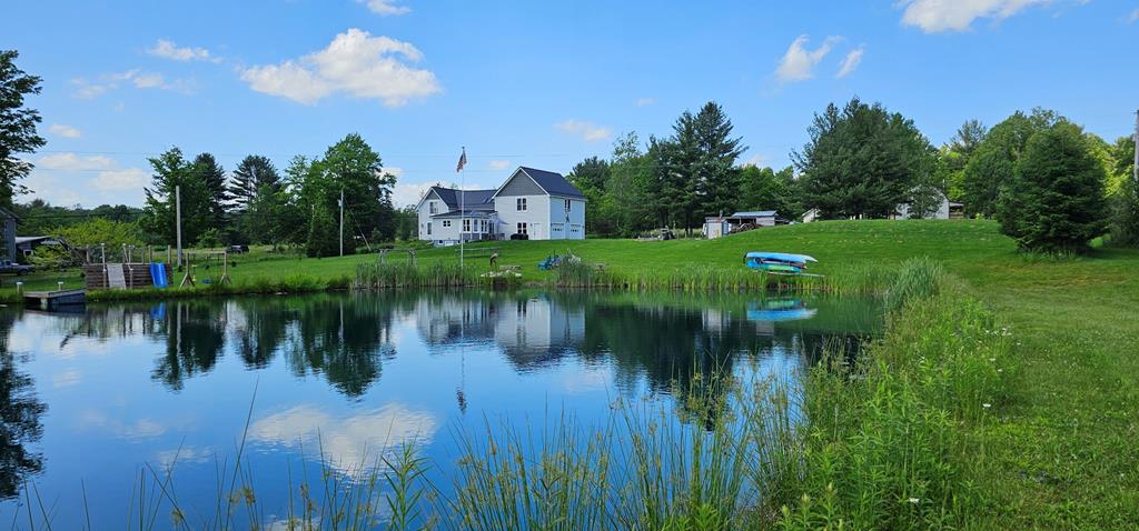 a view of a lake with a house in the background