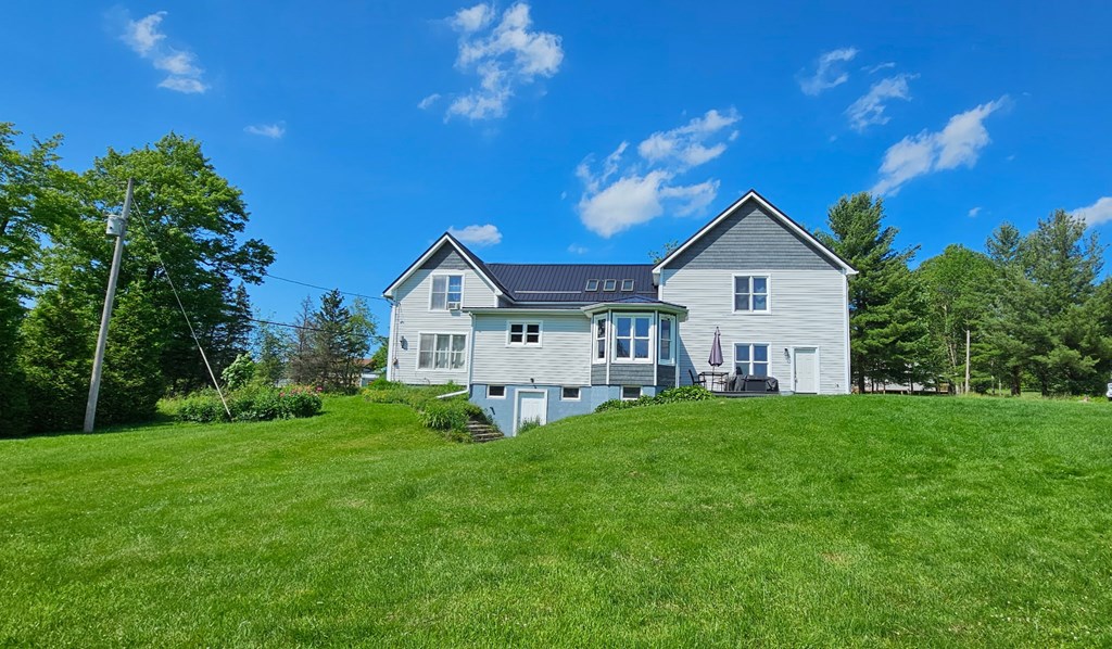 2761 Bush Road Spring Creek, PA 16436 - Photo 12 of 86 a view of a house with a big yard potted plants and large tree
