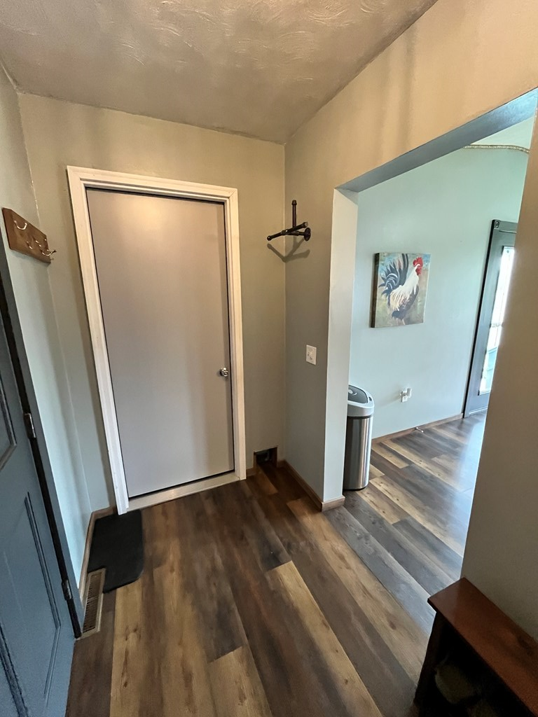 2761 Bush Road Spring Creek, PA 16436 - Photo 19 of 86 a view of a hallway with wooden floor and stairs