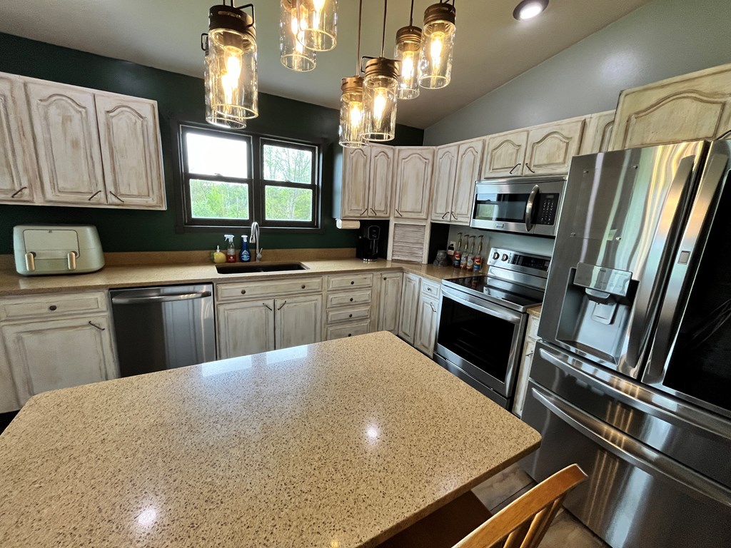 2761 Bush Road Spring Creek, PA 16436 - Photo 30 of 86 a kitchen with stainless steel appliances a sink stove and refrigerator