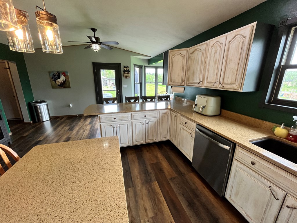 2761 Bush Road Spring Creek, PA 16436 - Photo 32 of 86 a large kitchen with a sink and dishwasher a stove top oven with wooden floor