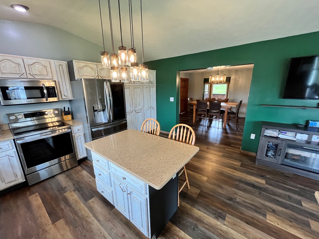 2761 Bush Road Spring Creek, PA 16436 - Photo 36 of 86 a kitchen with stainless steel appliances granite countertop a kitchen island a stove and a sink