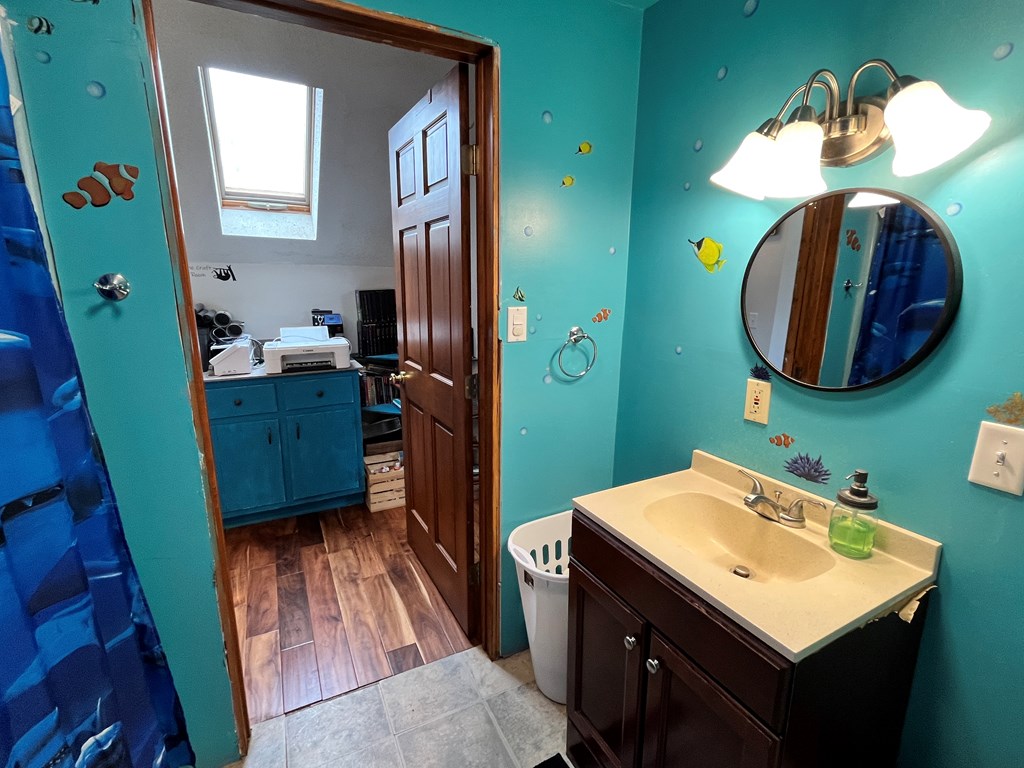 2761 Bush Road Spring Creek, PA 16436 - Photo 61 of 86 a bathroom with a sink mirror and vanity