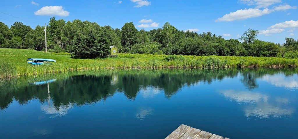 2761 Bush Road Spring Creek, PA 16436 - Photo 8 of 86 a view of a lake with a yard and large trees