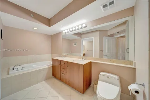 a kitchen with stainless steel appliances granite countertop a sink and a refrigerator