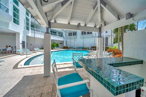 a view of a house with backyard porch and sitting area