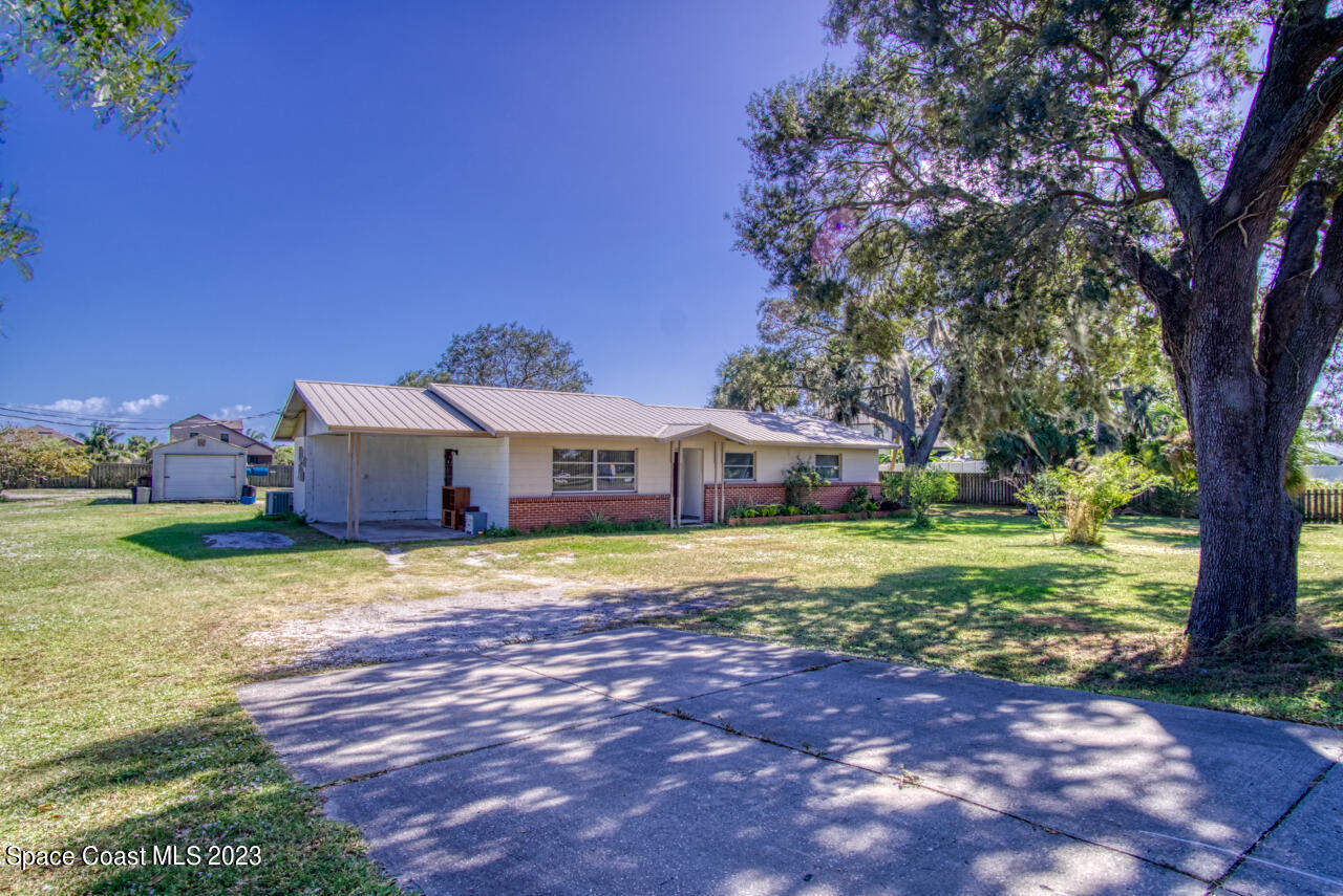 3101 Dairy Road Melbourne, FL 32901 - Photo 1 of 28 a front view of a house with a yard