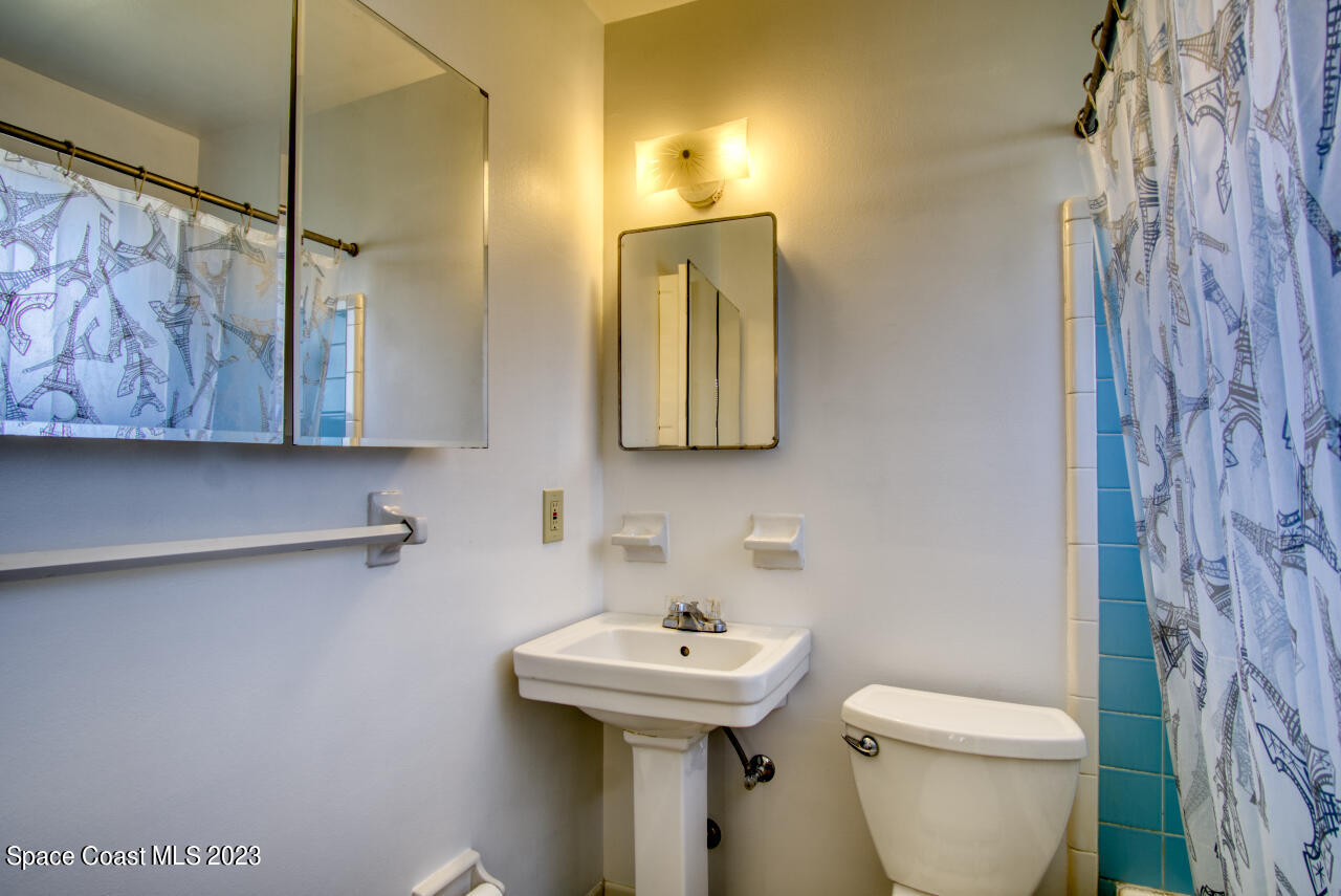 3101 Dairy Road Melbourne, FL 32901 - Photo 15 of 28 a bathroom with a toilet sink and mirror
