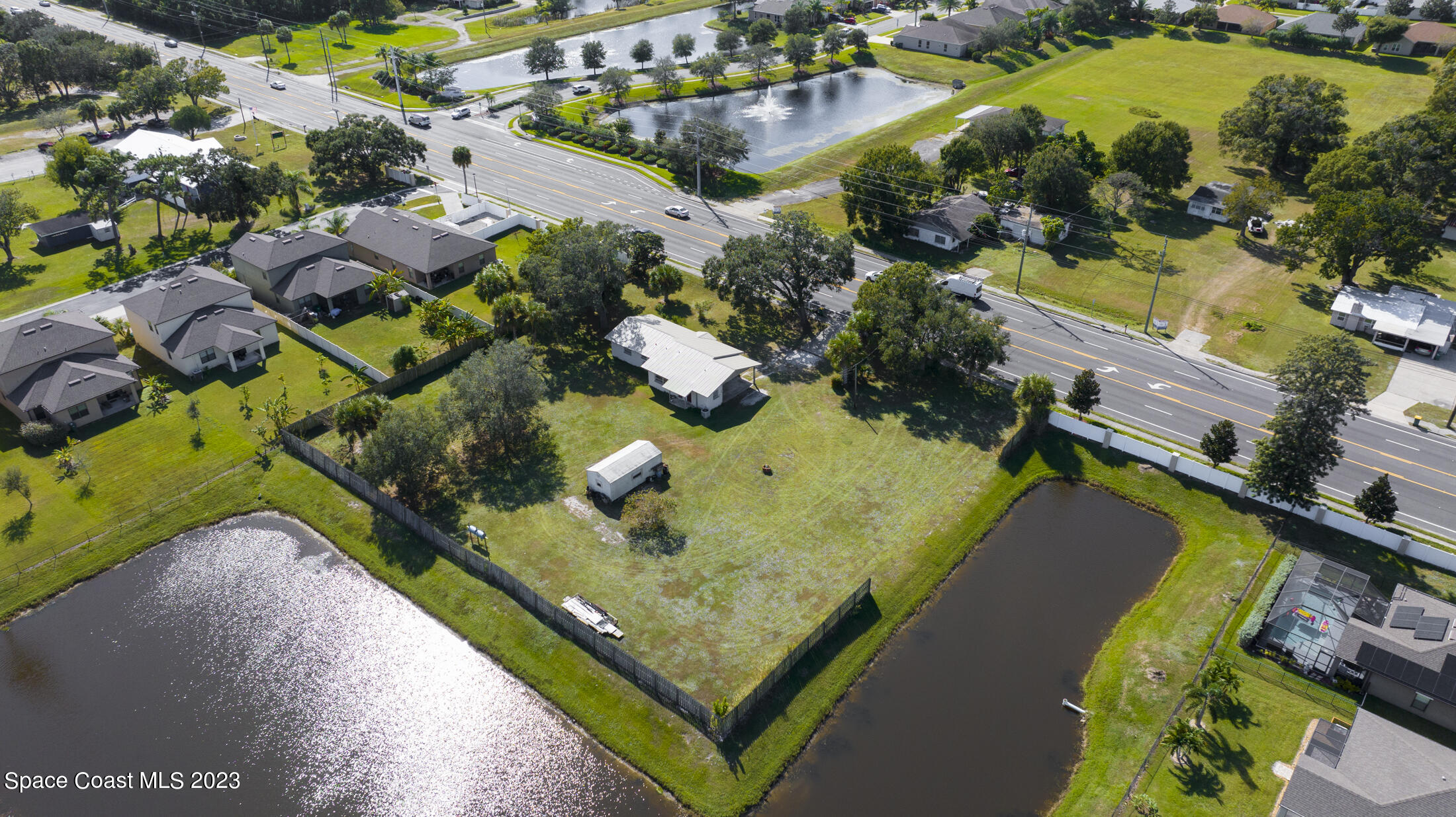 3101 Dairy Road Melbourne, FL 32901 - Photo 23 of 28 an aerial view of a house a yard and swimming pool