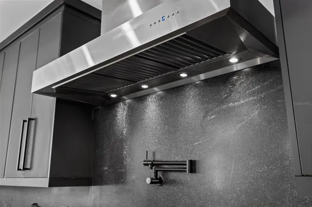 a spacious bathroom with a double vanity sink mirror and bathtub