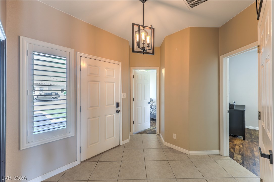 580 Lillian Condie Road Overton, NV 89040 - Photo 5 of 37 A welcoming entryway with tiled flooring and a contemporary overhead light fixture.