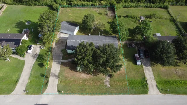 an aerial view of lake and residential houses with outdoor space