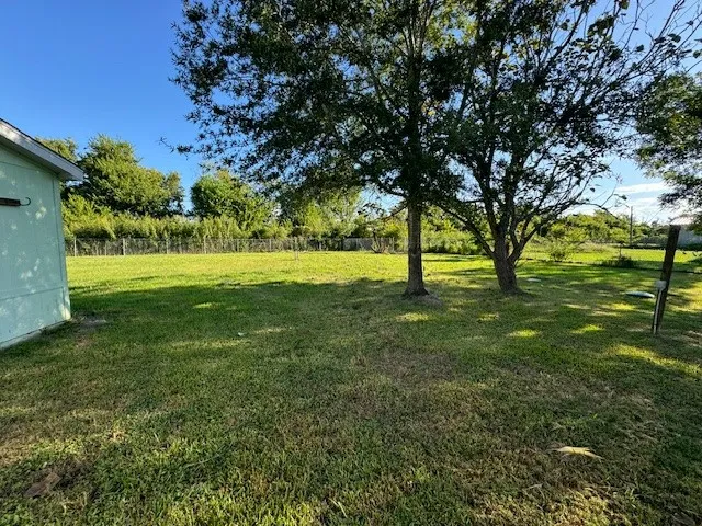 a view of field with trees in the background