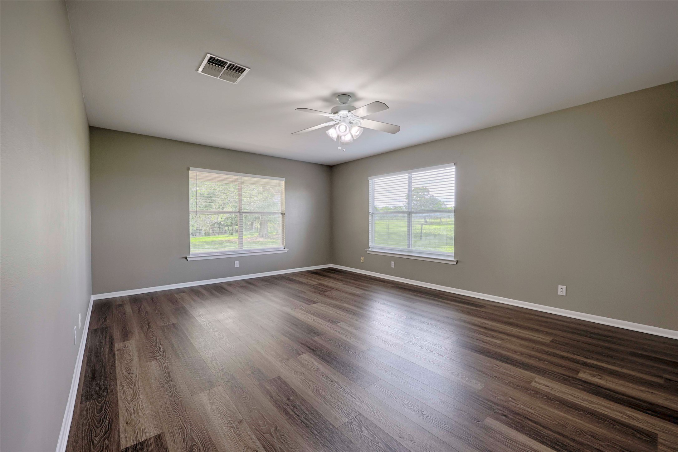 3545 East I- 10 Frontage Road Schulenburg, TX 78956 - Photo 17 of 40 an empty room with wooden floor and windows
