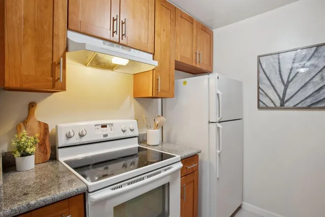 a kitchen with a stove and a refrigerator