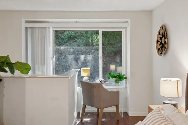 a living room with furniture and a potted plant