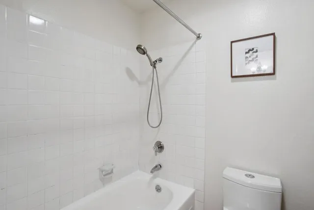 a bathroom with a bath tub with a toilet