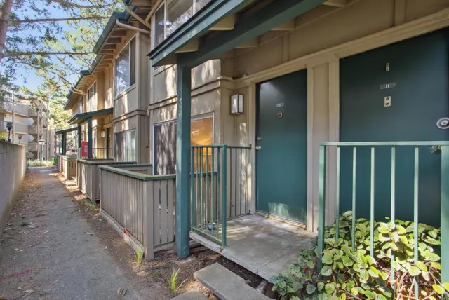 a view of a brick house with many windows