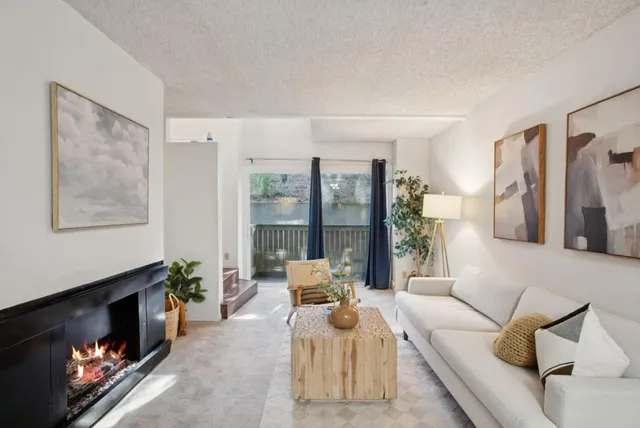 a living room with furniture fireplace and a flat screen tv