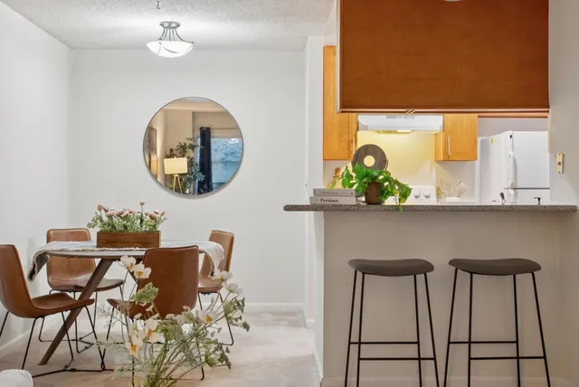 a view of a dining room with furniture and chandelier