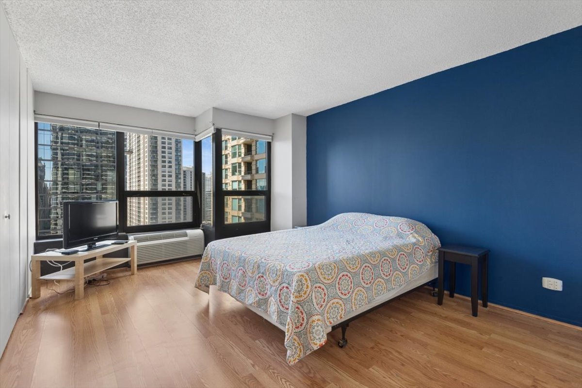 30 East Huron Street, Unit 2204 Chicago, IL 60611 - Photo 11 of 36 a bedroom with a bed and large window