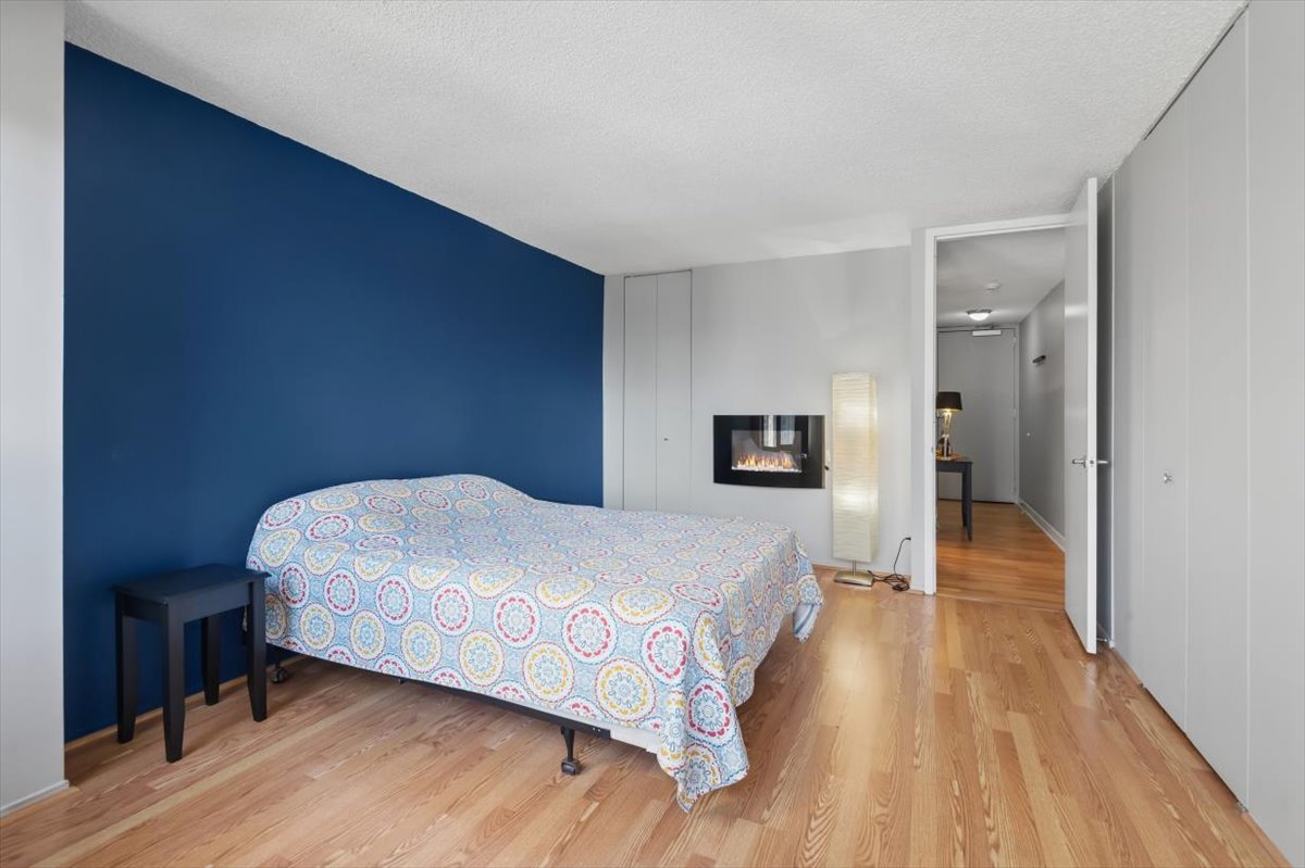 30 East Huron Street, Unit 2204 Chicago, IL 60611 - Photo 12 of 36 a spacious bedroom with a bed and a wooden floor
