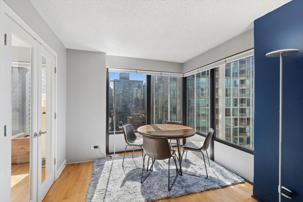 30 East Huron Street, Unit 2204 Chicago, IL 60611 - Photo 7 of 36 a view of a room with furniture and a window