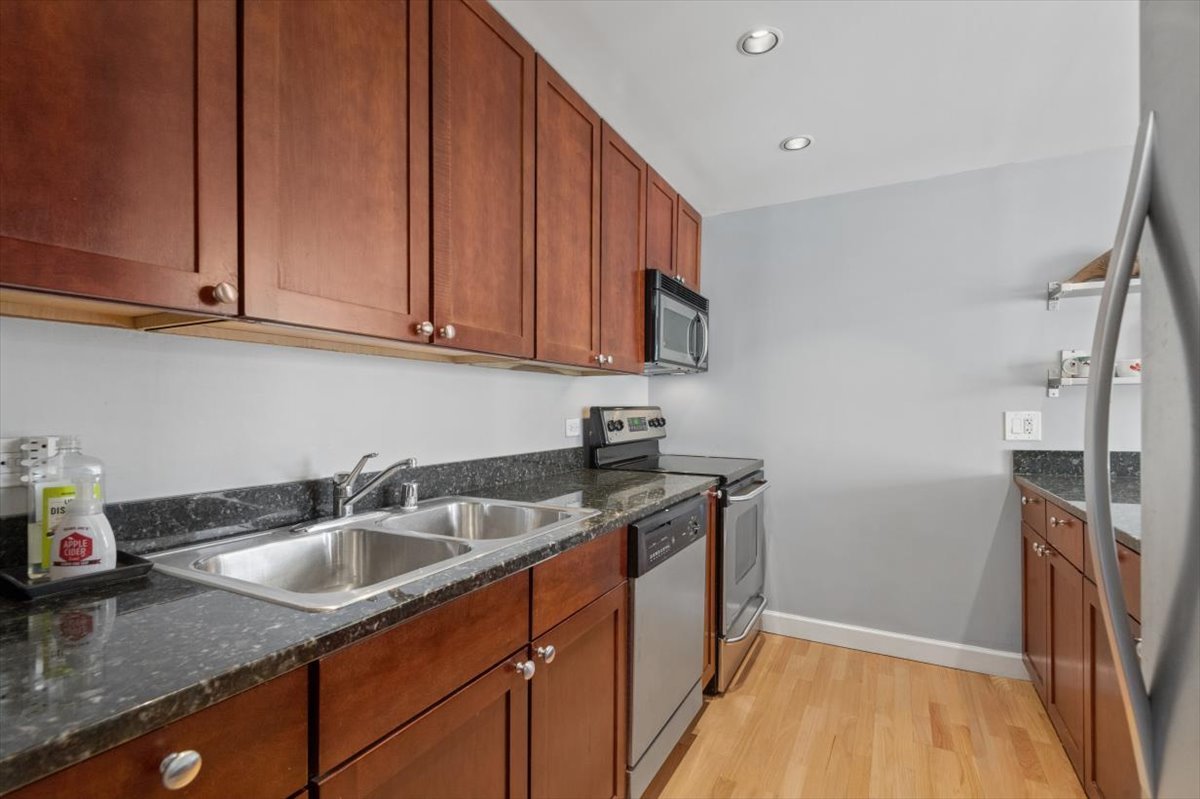 30 East Huron Street, Unit 2204 Chicago, IL 60611 - Photo 9 of 36 a kitchen with stainless steel appliances granite countertop a sink stove and cabinets