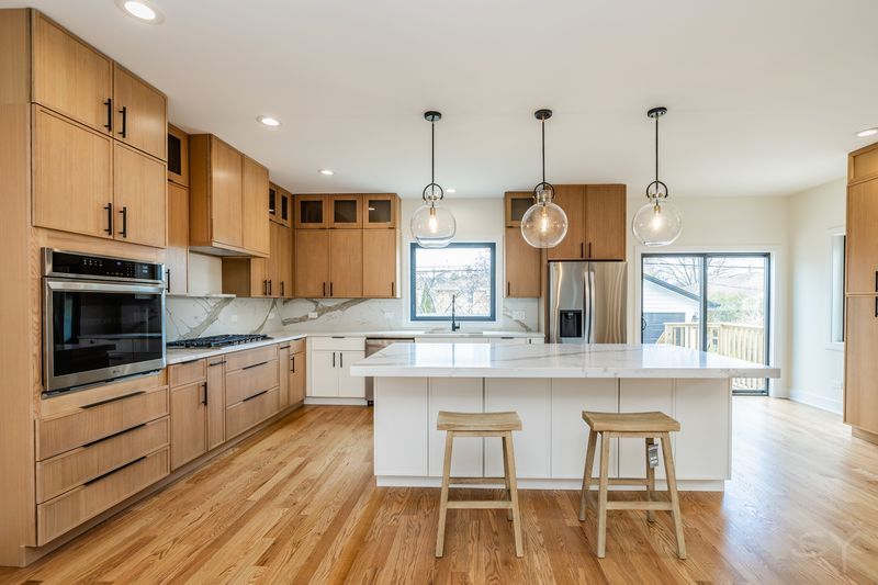 2247 South 6th Avenue North Riverside, IL 60546 - Photo 15 of 57 a kitchen with stainless steel appliances granite countertop a kitchen island hardwood floor and a sink
