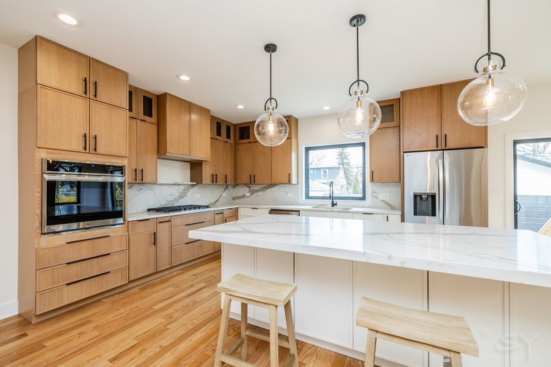 2247 South 6th Avenue North Riverside, IL 60546 - Photo 16 of 57 a kitchen with stainless steel appliances granite countertop a sink a stove and a refrigerator