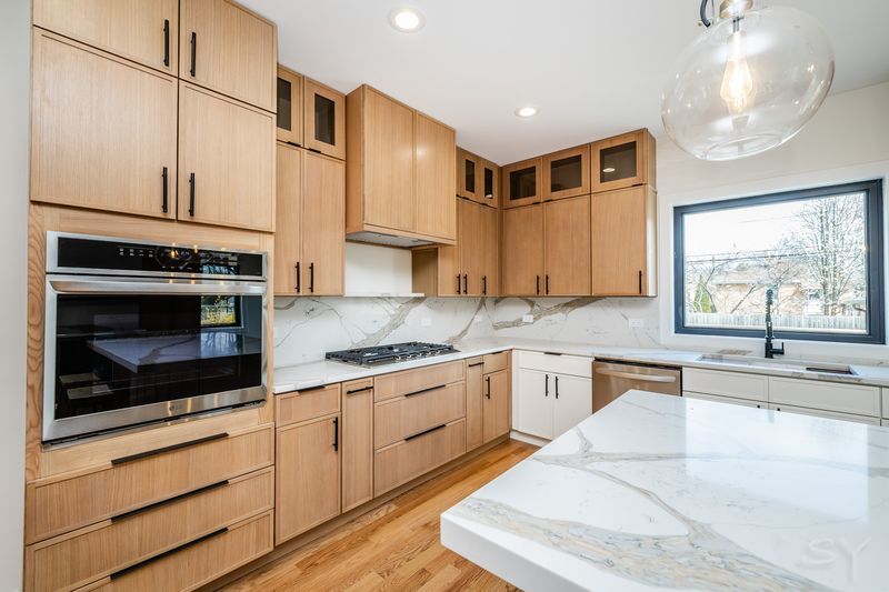 2247 South 6th Avenue North Riverside, IL 60546 - Photo 18 of 57 a kitchen with stainless steel appliances granite countertop a stove a sink and a microwave