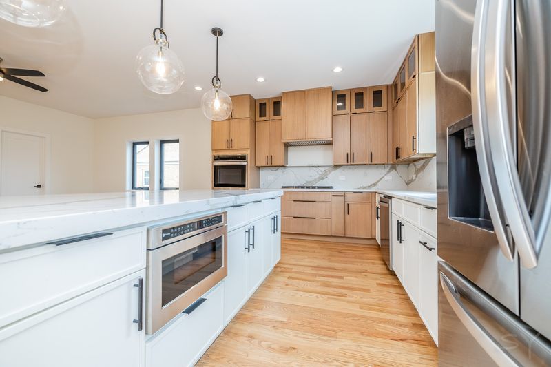 2247 South 6th Avenue North Riverside, IL 60546 - Photo 21 of 57 a large kitchen with stainless steel appliances granite countertop a sink a stove and a refrigerator