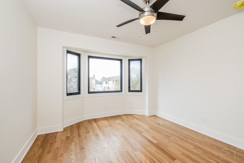 2247 South 6th Avenue North Riverside, IL 60546 - Photo 26 of 57 an empty room with wooden floor fan and windows