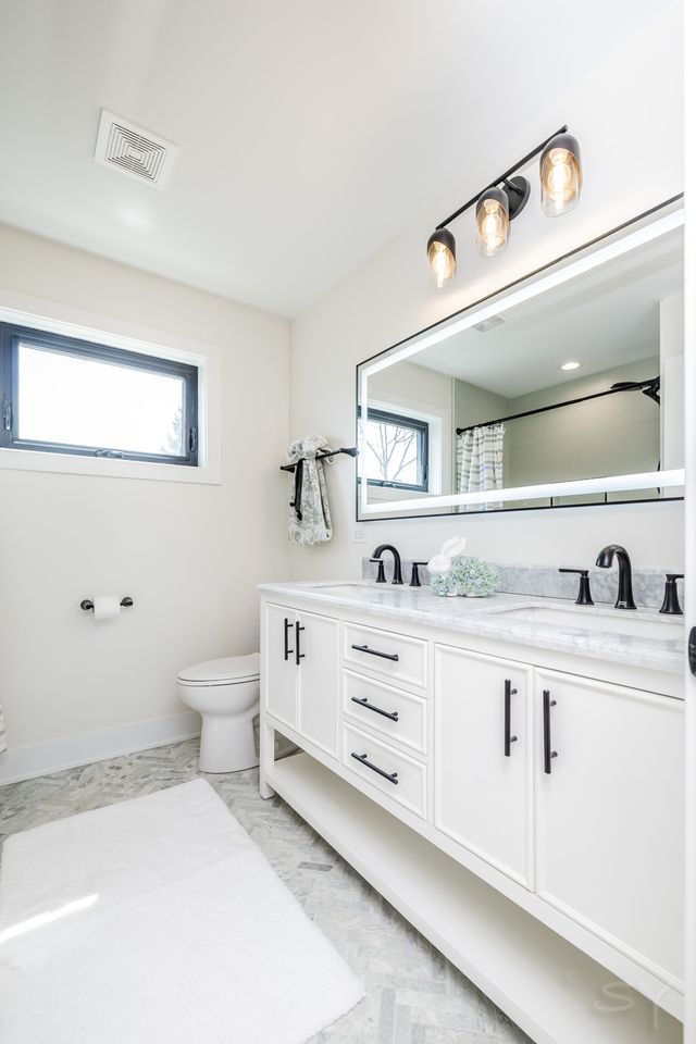 2247 South 6th Avenue North Riverside, IL 60546 - Photo 38 of 57 a bathroom with a sink double vanity and a toilet