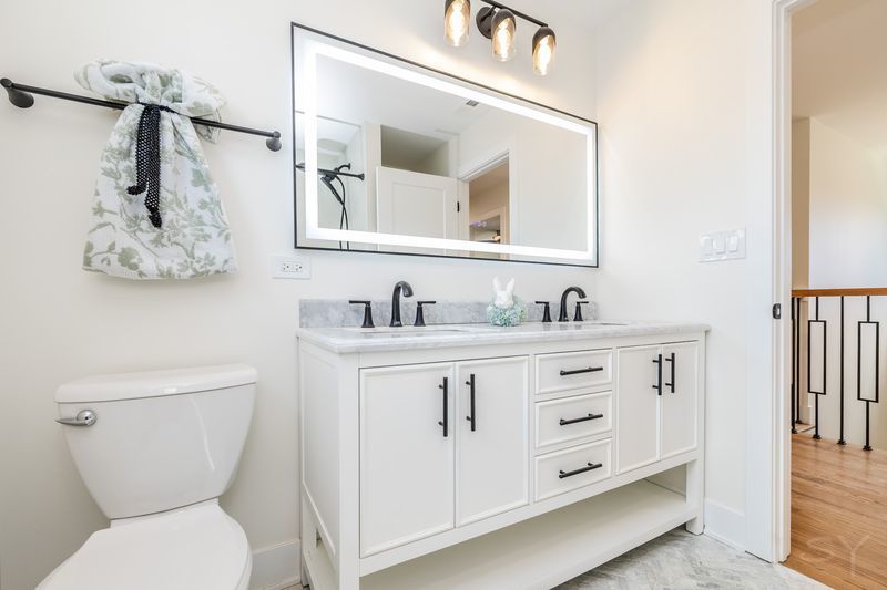 2247 South 6th Avenue North Riverside, IL 60546 - Photo 40 of 57 a bathroom with a granite countertop toilet sink and mirror