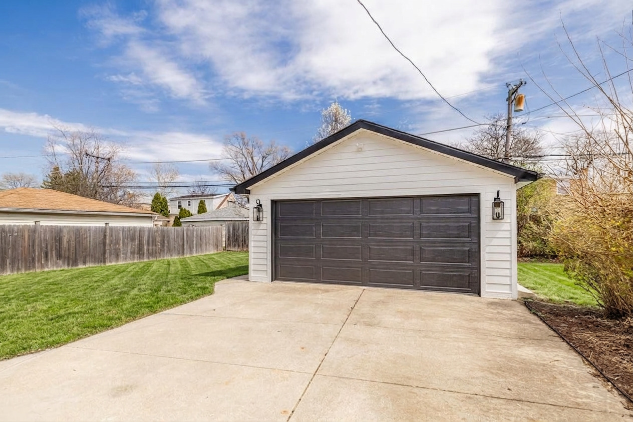 2247 South 6th Avenue North Riverside, IL 60546 - Photo 56 of 57 a front view of a house with a yard and garage