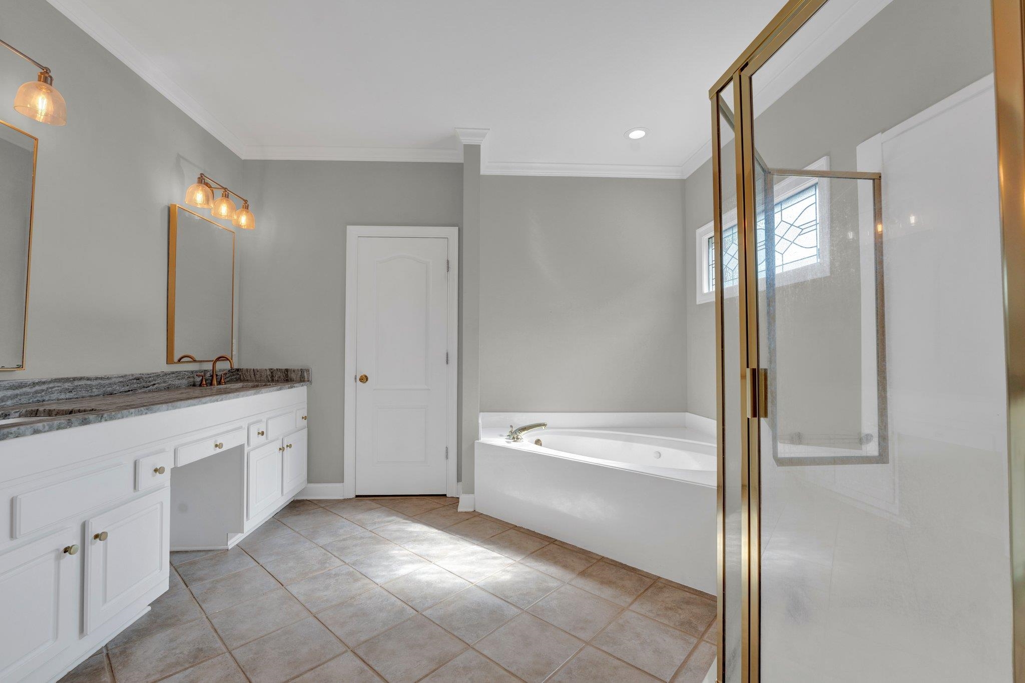 1331 Riding Brook Drive Collierville, TN 38017 - Photo 20 of 39 Bathroom with vanity, tile patterned flooring, independent shower and bath, and ornamental molding