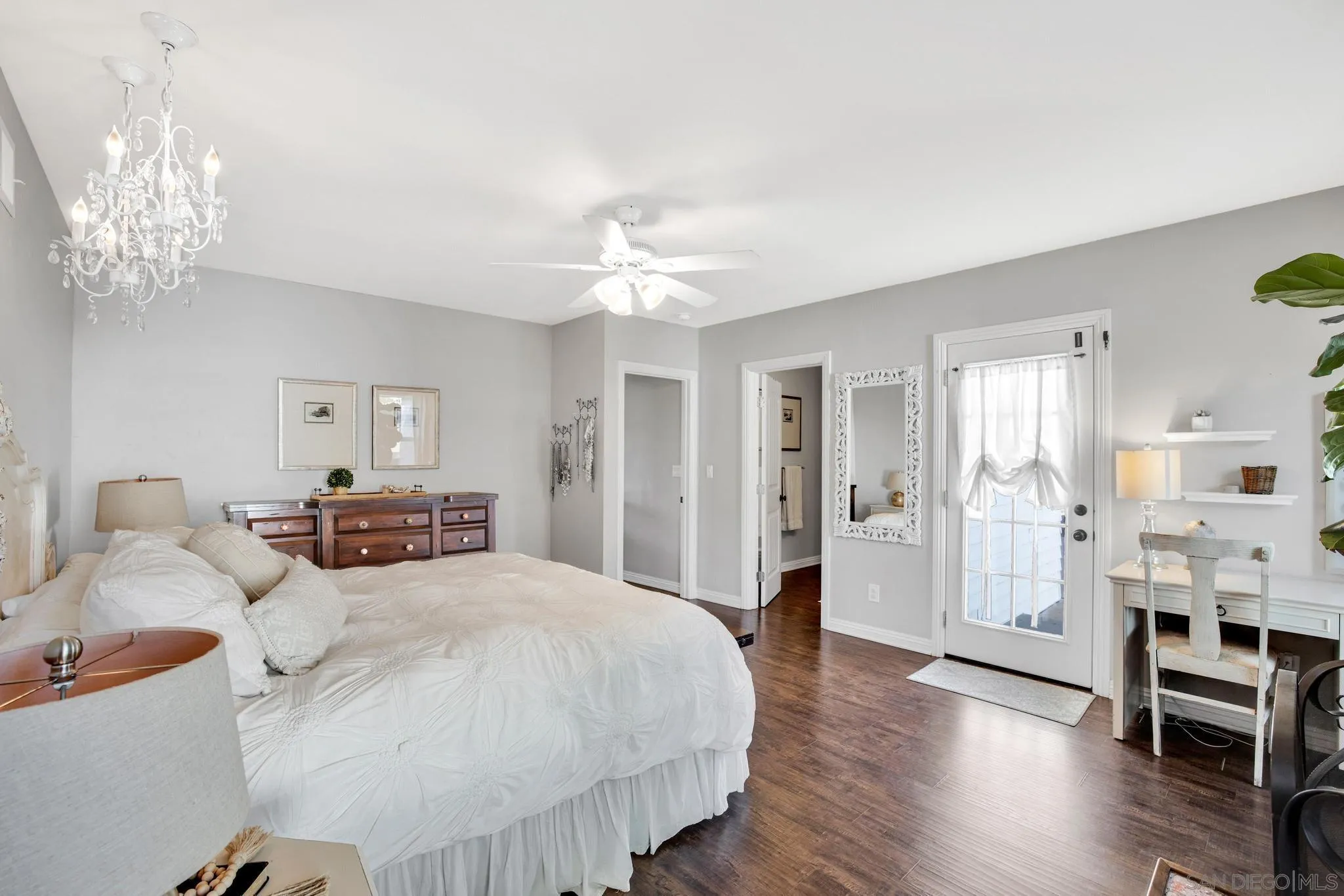 14409 Rios Canyon Road El Cajon, CA 92021 - Photo 28 of 47 a spacious bedroom with a bed and a chandelier