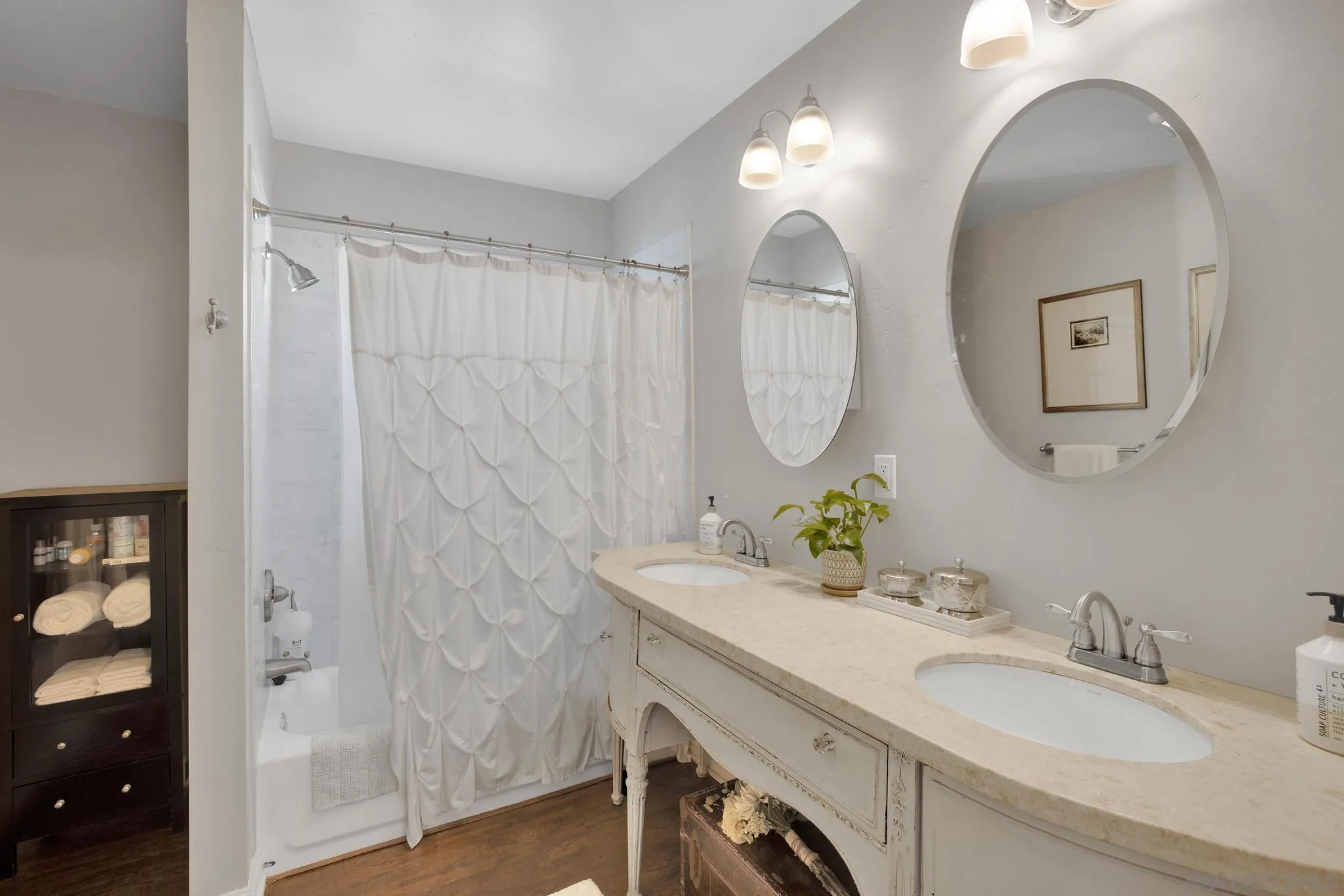 14409 Rios Canyon Road El Cajon, CA 92021 - Photo 29 of 47 a bathroom with a double vanity sink and a mirror
