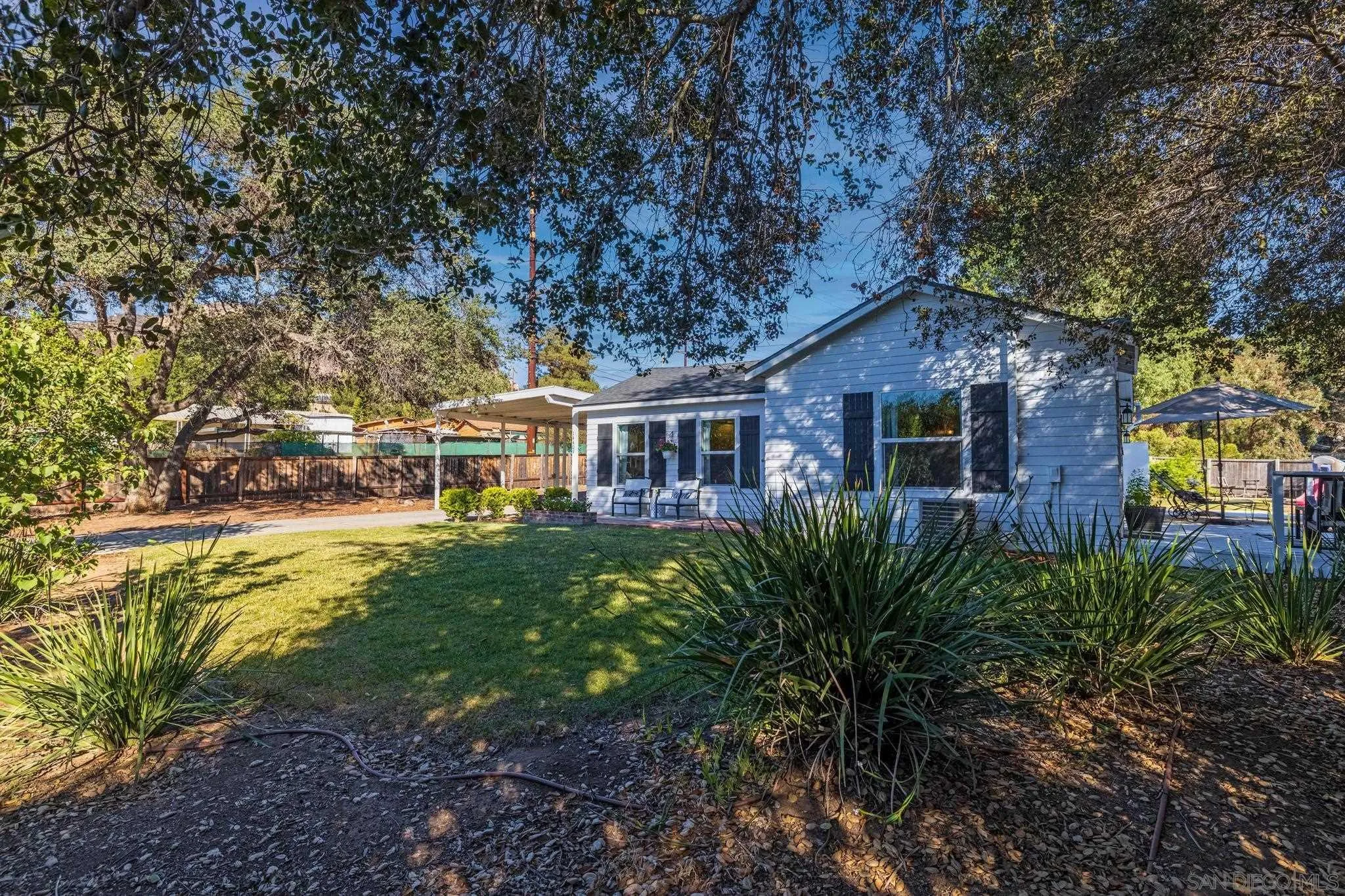 14409 Rios Canyon Road El Cajon, CA 92021 - Photo 42 of 47 a front view of a house with garden