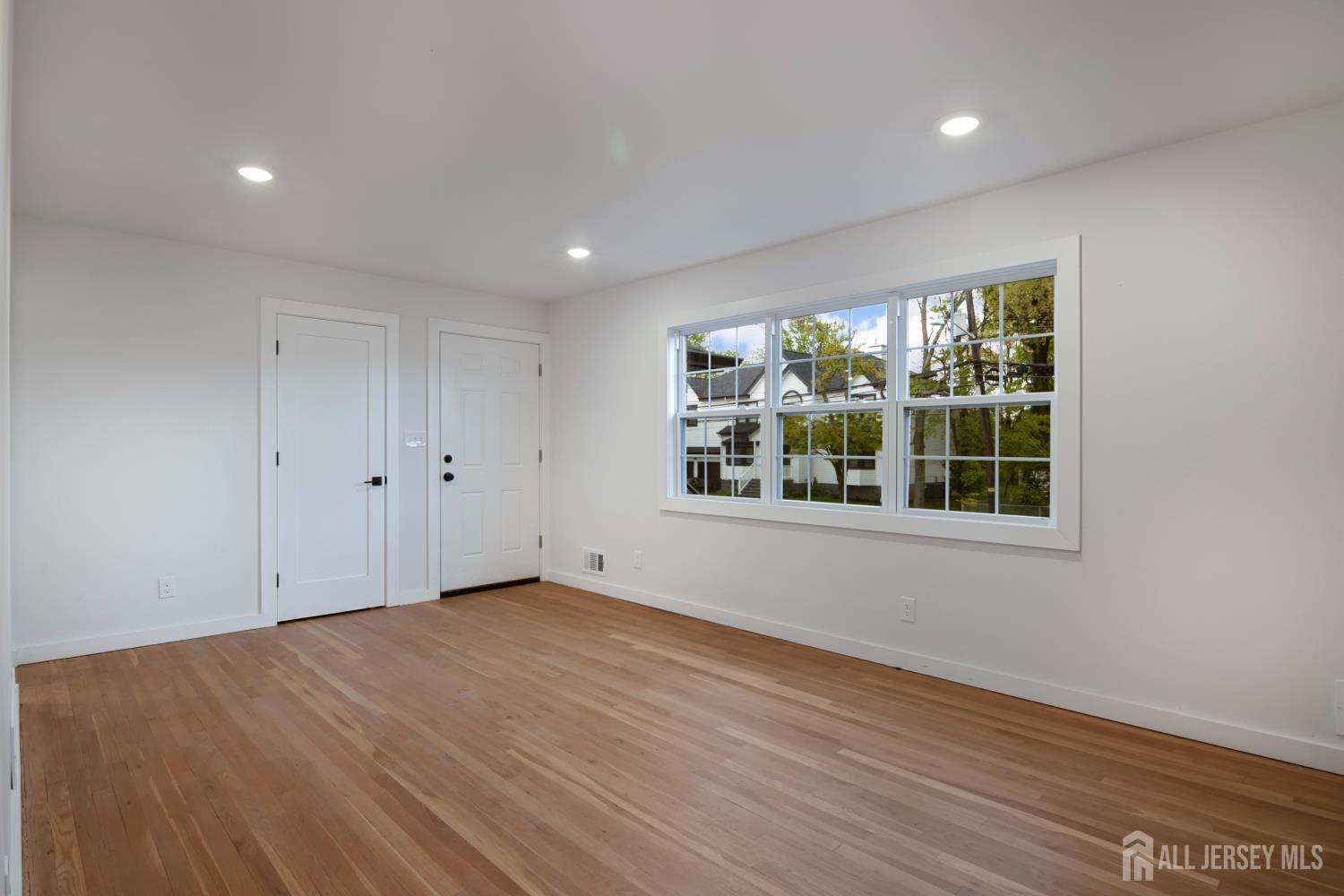 4 Morris Avenue, Unit 2A Edison, NJ 08837 - Photo 23 of 27 a view of an empty room with wooden floor and a window
