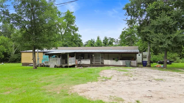 a view of a house with a yard porch and sitting area
