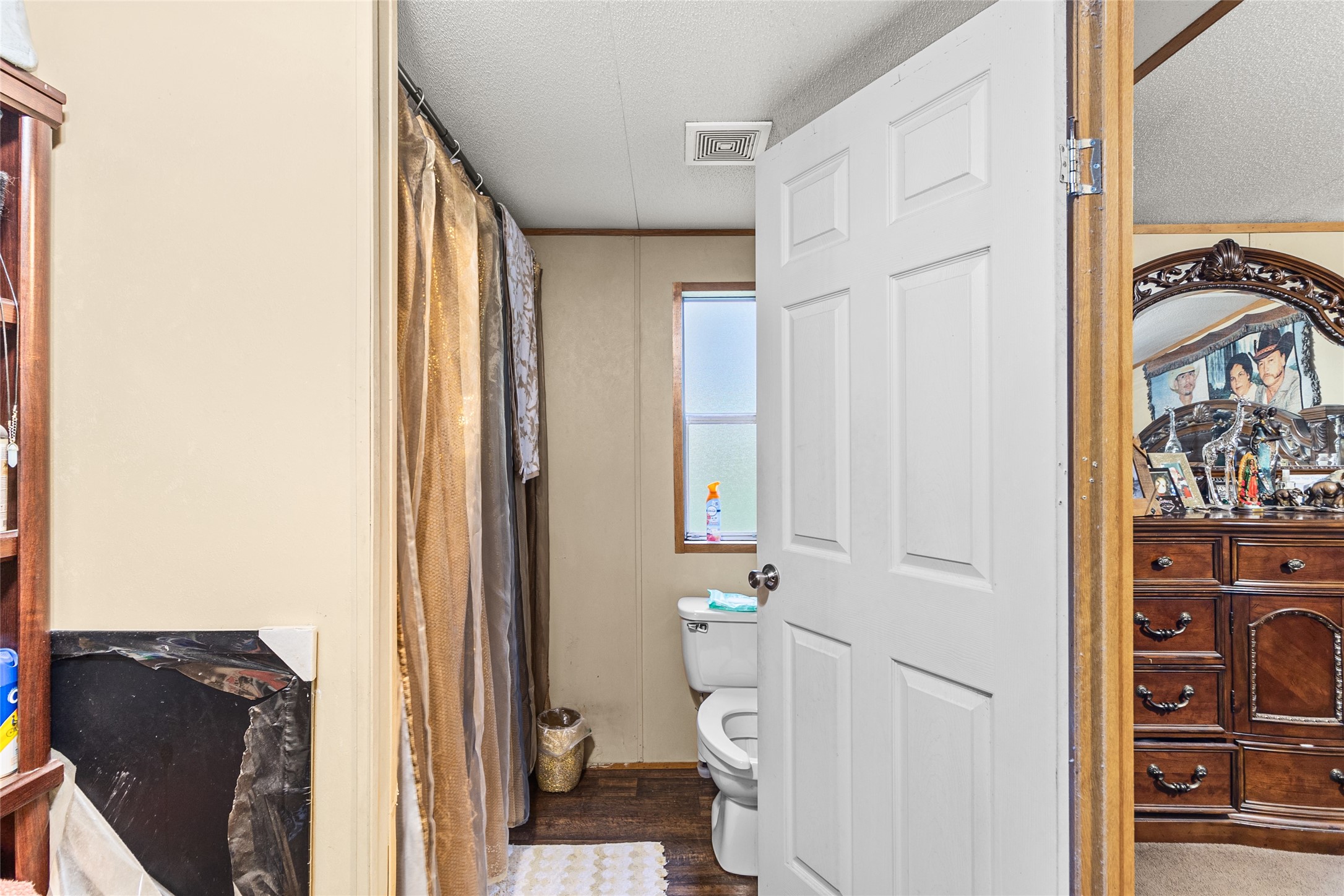 228 Geneva Road Huntsville, TX 77320 - Photo 11 of 26 a bathroom with a toilet and a shower