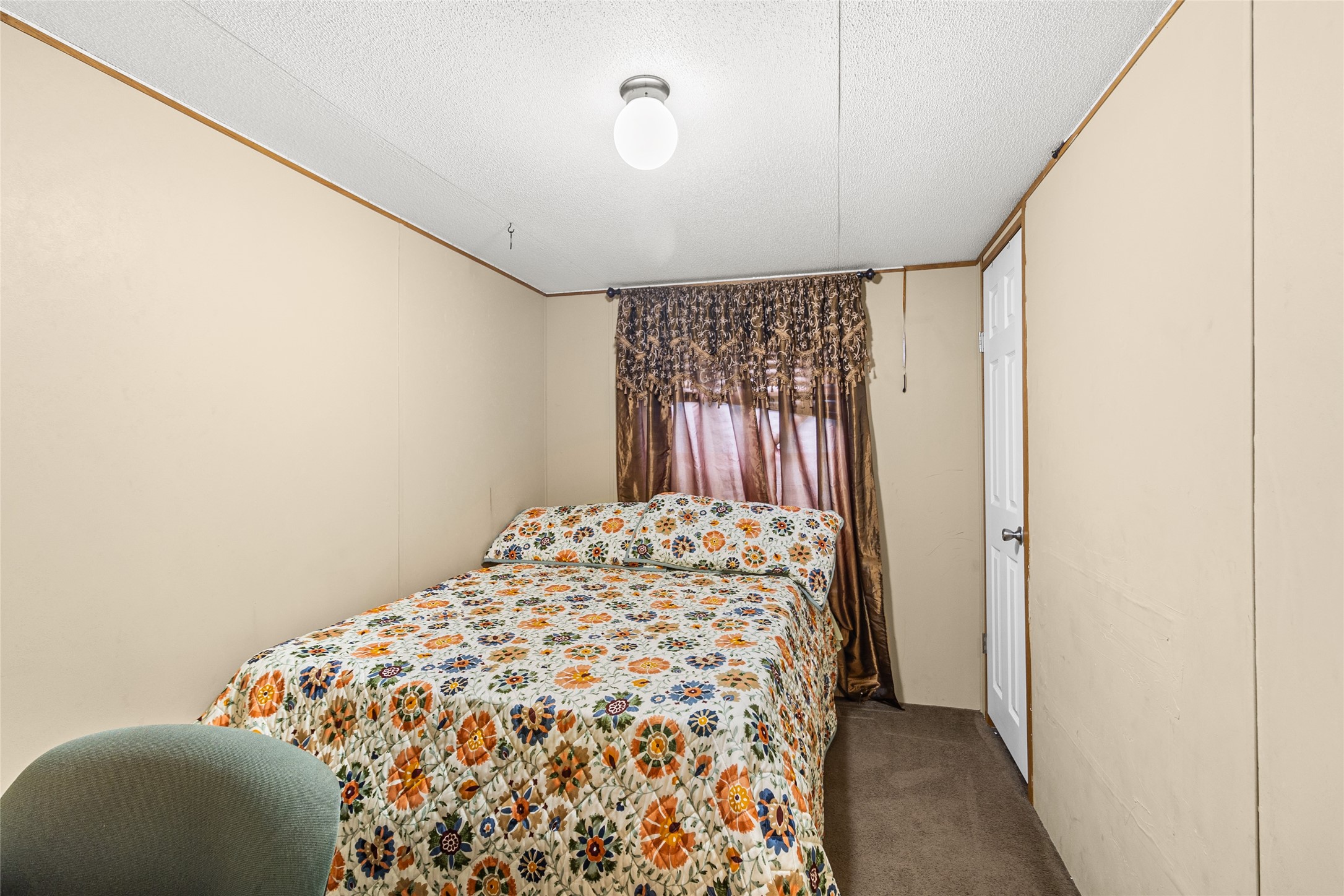 228 Geneva Road Huntsville, TX 77320 - Photo 12 of 26 a bedroom with a bed and a window