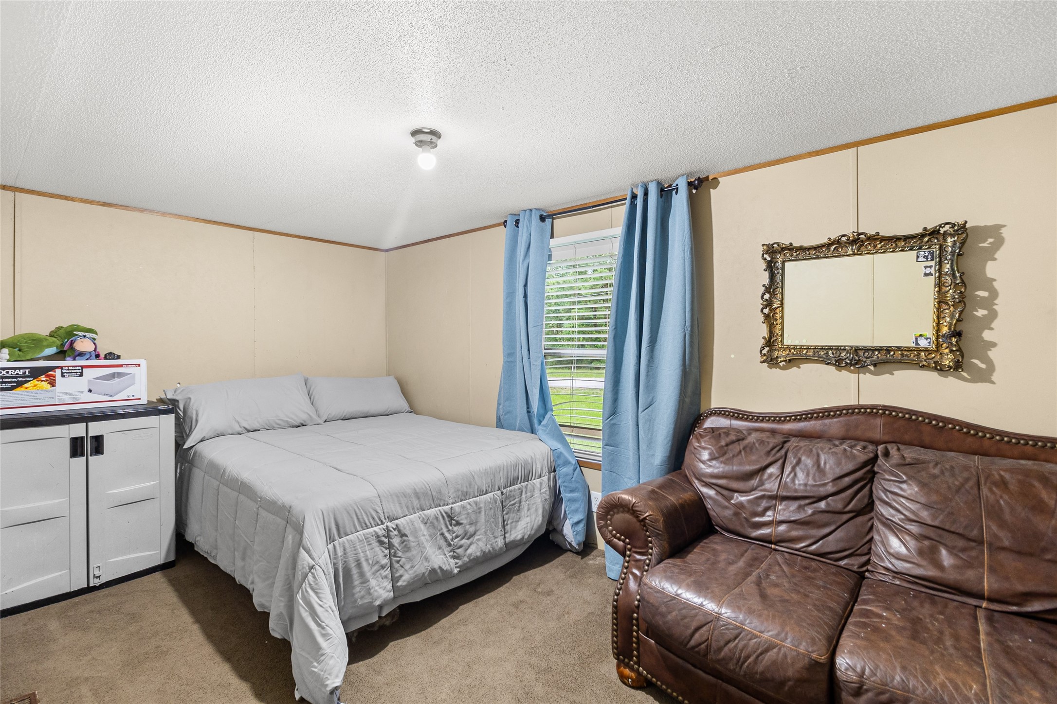 228 Geneva Road Huntsville, TX 77320 - Photo 14 of 26 a bedroom with a bed couch and window