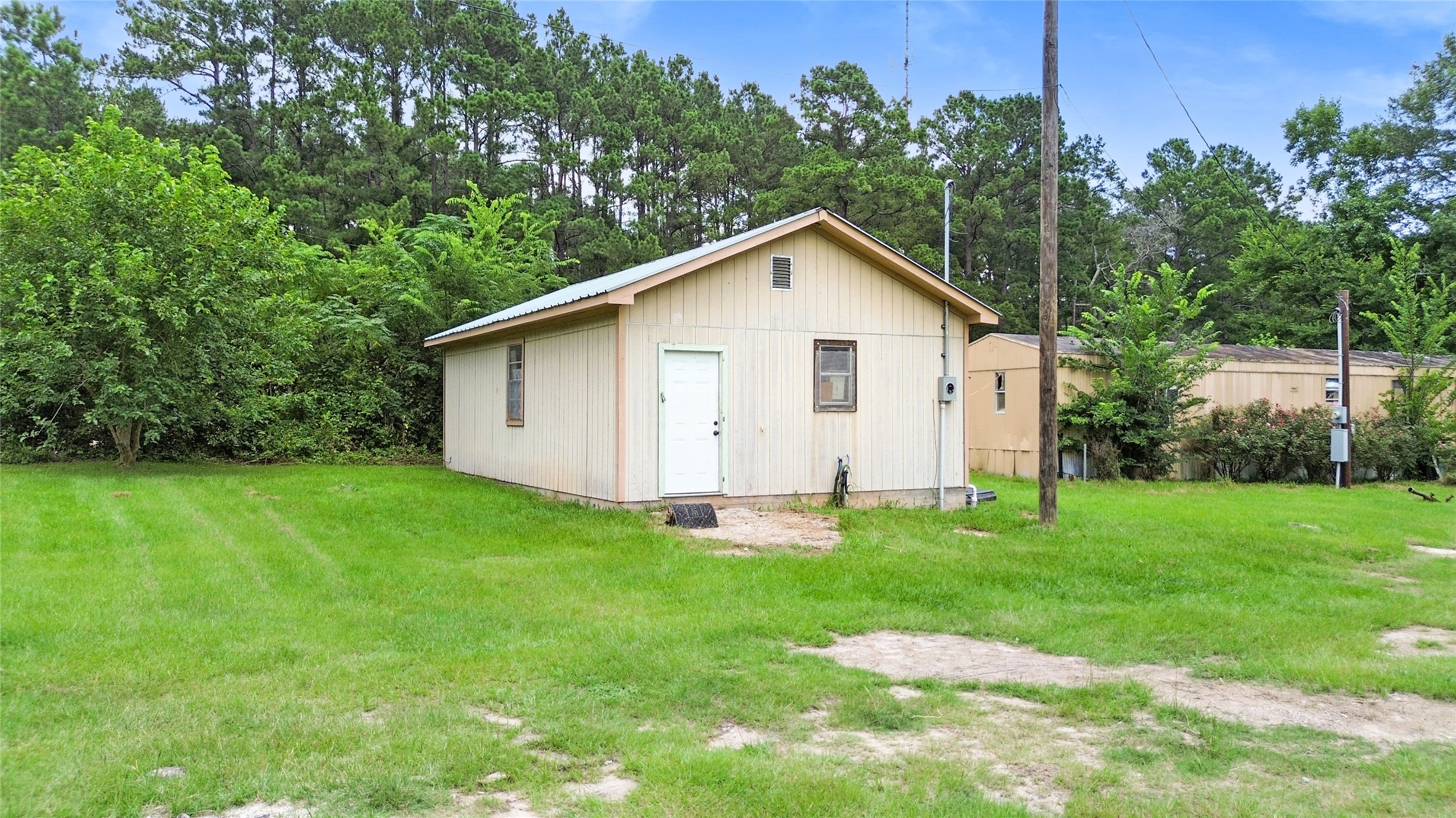 228 Geneva Road Huntsville, TX 77320 - Photo 22 of 26 a view of a house with backyard and garden