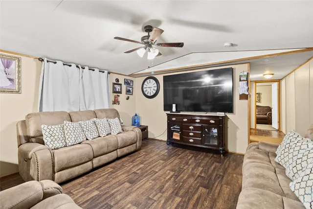 a living room with furniture a flat screen tv and a couch